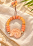 Coral peach and amber bracelet with pale pink spiral shell centerpiece