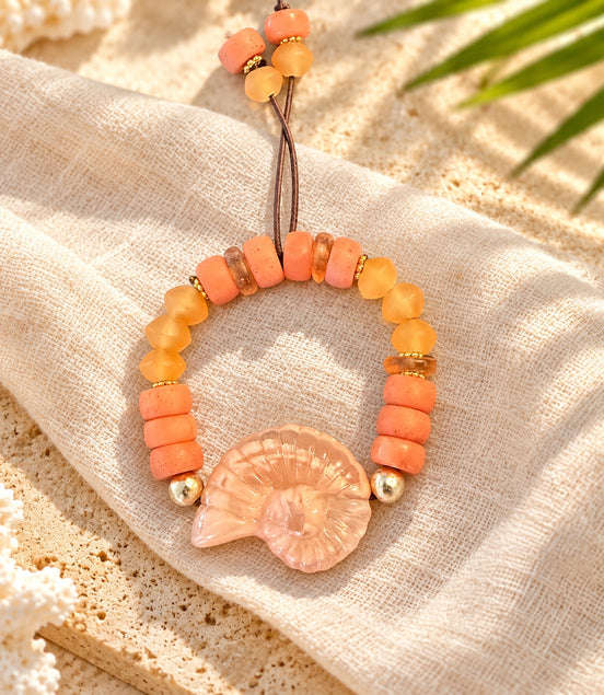 Coral peach and amber bracelet with pale pink spiral shell centerpiece