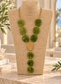 Olive green statement necklace with gold-tone spiral centerpiece